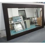 WALL MIRROR, of extremely large proportions, dark wood frame, bevelled plate,