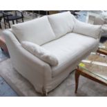 SOFA, two seater, in ivory loose covers on turned supports, 176cm L.