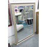 MIRROR, bevelled in a silvered ribbed frame, 130cm x 90cm.