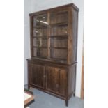 GLAZED BOOKCASE, in two sections with sliding doors, 50cm x 128cm x 218cm H.