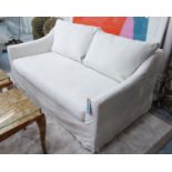 SOFA, two seater, in ivory loose covers on turned supports, 176cm L.