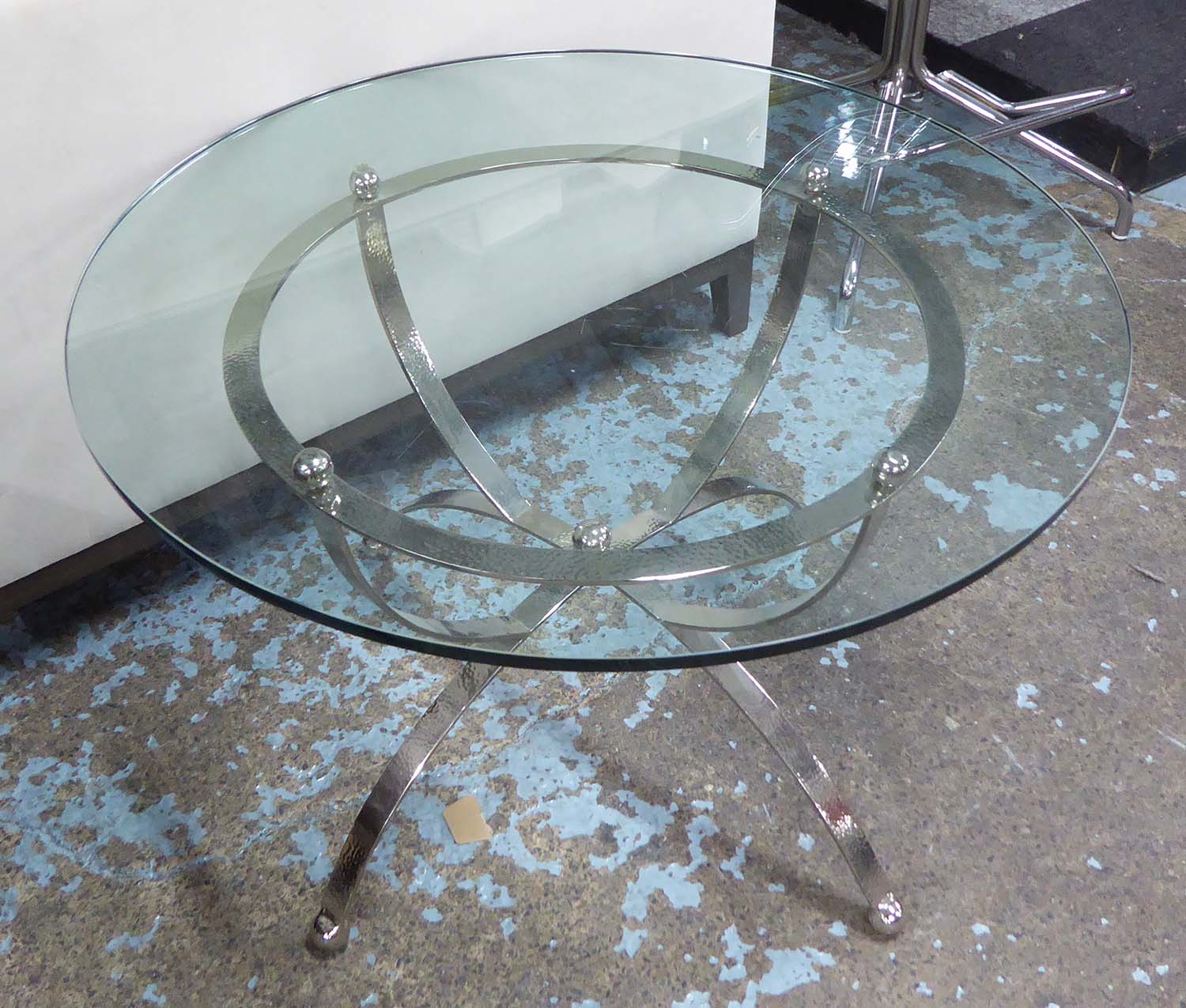 LOW TABLE, circular top on hammered silvered base, approx 71cm D.