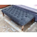 HEARTH STOOL, in dark blue buttoned fabric on turned castor supports, 126cm x 63cm x 36cm H.