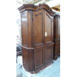 ARMOIRE, carved wood with panelled doors and canted corners, 225cm H x 155cm x 59cm.