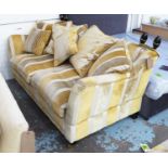 KNOLE SOFA, two seater in striped fabric, with six scatter cushions on turned castor supports,