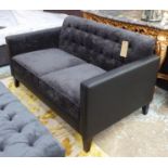 SOFA, in charcoal upholstery with black leather button back on tapered dark wood legs,