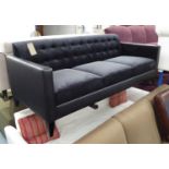 SOFA, in charcoal upholstery with black leather button back on tapered dark wood legs,