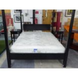 FOUR POSTER BED 5'-0', in ebonised wood, with chromed metal mounts and a hypnos mattress,