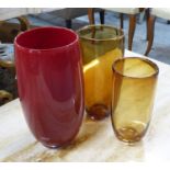 VASES, a graduated set of three, in glass, one red, the others amber, possibly Whitefriars, largest,