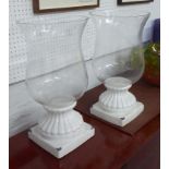 GLASS FLOWER VASES, a pair, with fixed glazed china bases continental style, 50cm H x 20cm.