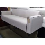 CONTEMPORARY SOFA, neutral fabric with brown trim on tapered supports.