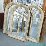 MIRRORS, a set of three, with domed tops in a distressed painted frame, 94cm x 55cm.