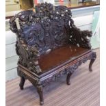 BENCH, early 20th century Chinese lacquer with boldly carved dragon back and arm supports,