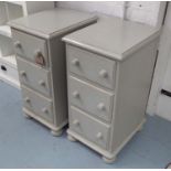 BEDSIDE CHESTS, a pair, with three drawers and knob handles on bun feet,