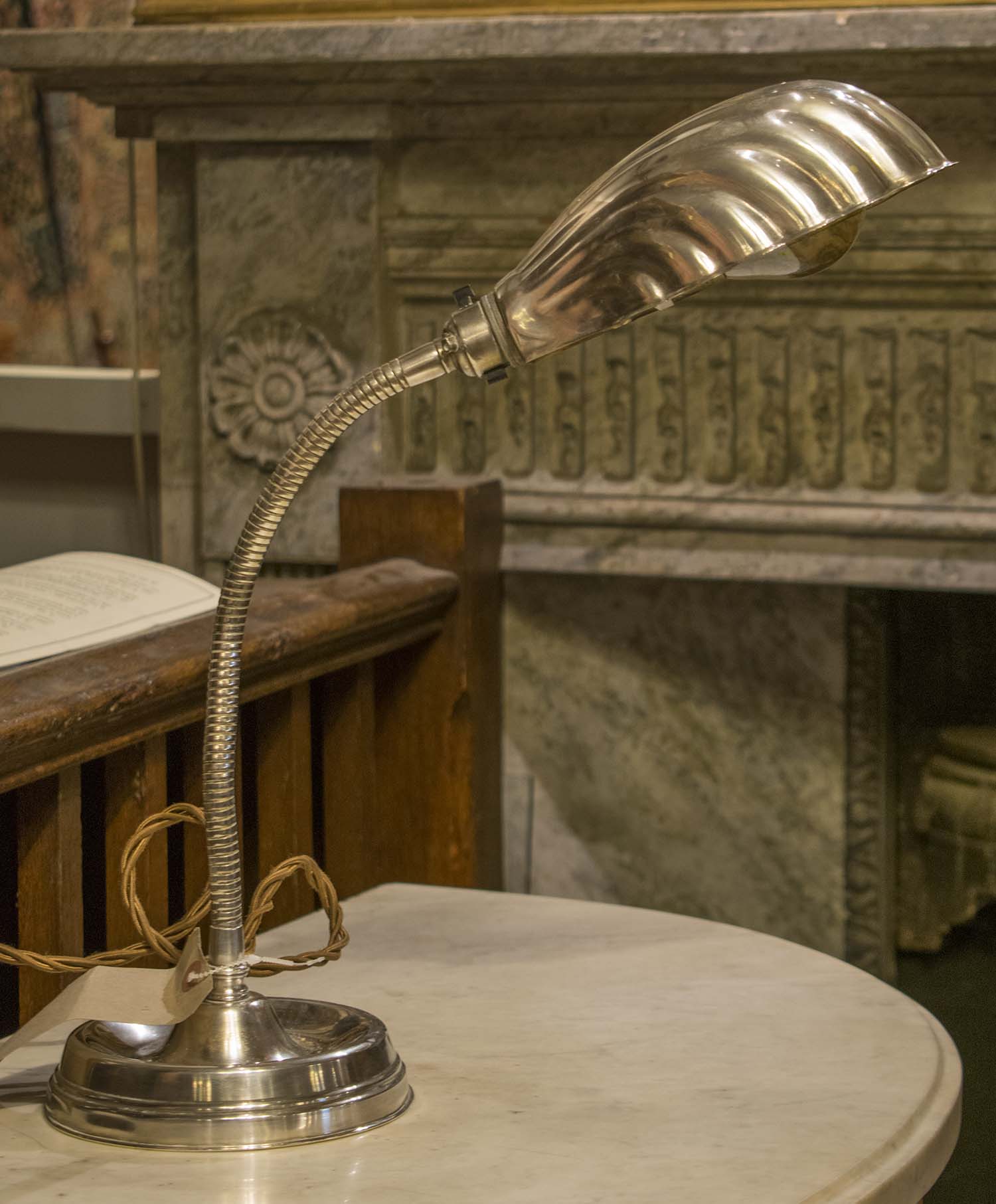 DESK LAMP, early 20th century, silvered metal with adjustable, articulated support and shell shade,