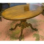 LOO TABLE, Victorian rosewood with oval tilt top on a carved pedestal and castors,
