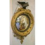 CONVEX MIRROR, Regency giltwood and ebonised with eagle crest and foliate decoration,