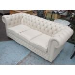 CHESTERFIELD SOFA, three seater, with buttoned cream leather upholstery on bun feet,