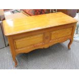 BLANKET BOX, in cherrywood, with a hinged lid on raised supports, 130cm 53cm 67cm H.