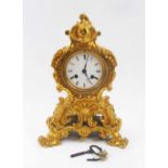 LOUIS XV MANTEL CLOCK, the florid cast gilt metal case, with white enamel dial,