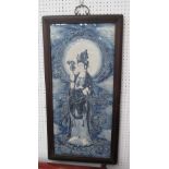 WALL PLAQUE OF QUAN YIN, blue and white in a black frame, 90cm x 45cm.