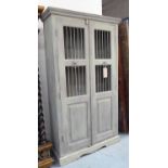 STORAGE CABINET, in a grey distressed finish with panelled and grilled doors,