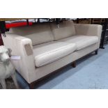 SOFA, two seater, contemporary design in oatmeal upholstery on darkened splayed legs,