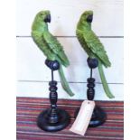 TABLE ORNAMENTS, two, in the form of green parrots, on stand, 43cm H.