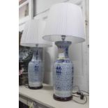LAMPS, a pair, Chinese style blue and white converted vases on bases, with shades, 100cm H.