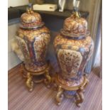 IMARI CERAMIC JARS, a pair, of inverted baluster form, the lids with Foo Dog finials,
