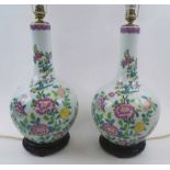 CHINESE CERAMIC BOTTLE VASE LAMPS, a pair, each decorated chrysanthemums in colours, wooden bases,