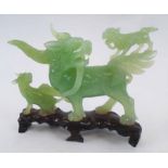 JADE DRAGON CARVING, 20th century, on wooden stand, 19cm x 13cm H max.