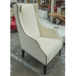 ARMCHAIR, in cream with piping on square supports.