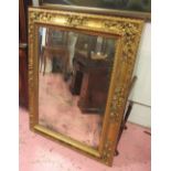 WALL MIRROR, late 19th century Continental rectangular giltwood with ornate scroll decoration,