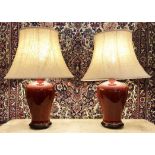 TABLE LAMPS, a pair, Chinese sang de boeuf glazed on wooden bases with silk shades, 72cm H.