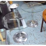 OCCASIONAL TABLES, a pair, circular with glass tops on chromed metal bases, 76cm diam x 72cm H.