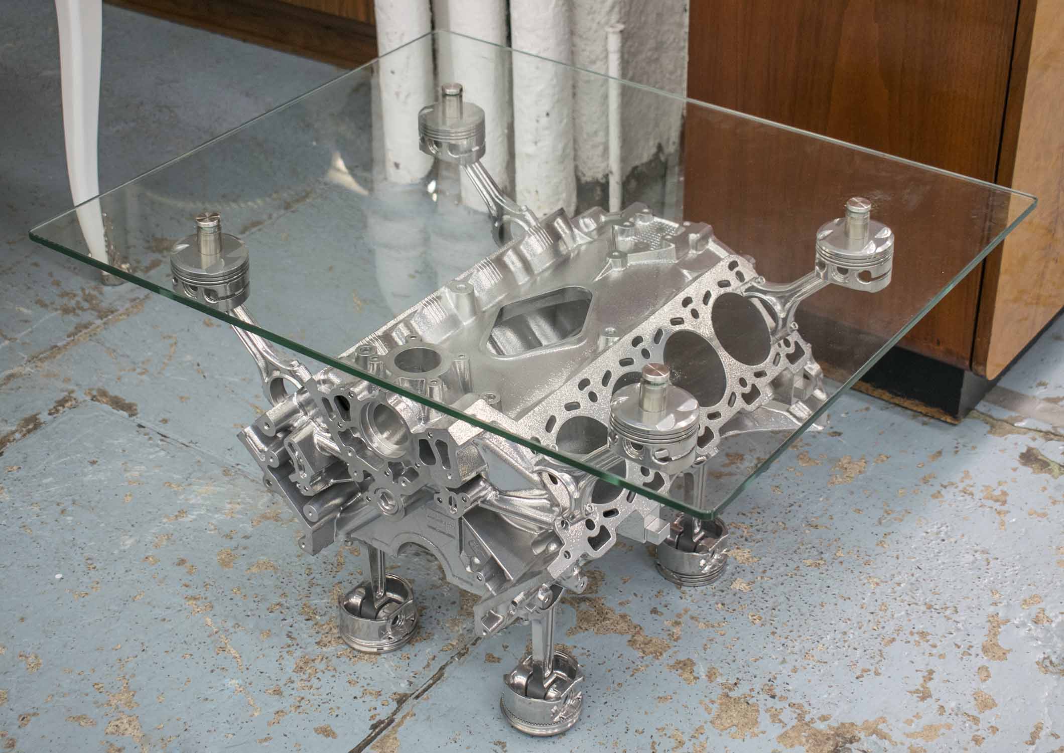 JAGUAR ENGINE LOW TABLE, cast metal with rectangular glass top, 80cm W x 67cm D x 51cm H.