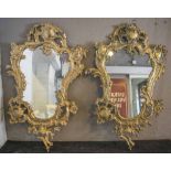 WALL MIRRORS, two similar Louis XV style brass, each with foliate cast cartouche shaped frame,