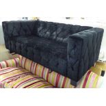 SOFA, two seater, in buttoned black fabric on square supports, 179cm L.