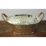 CHAMPAGNE BATH, oval hammered effect in a plated finish with leather handles, 62cm W.