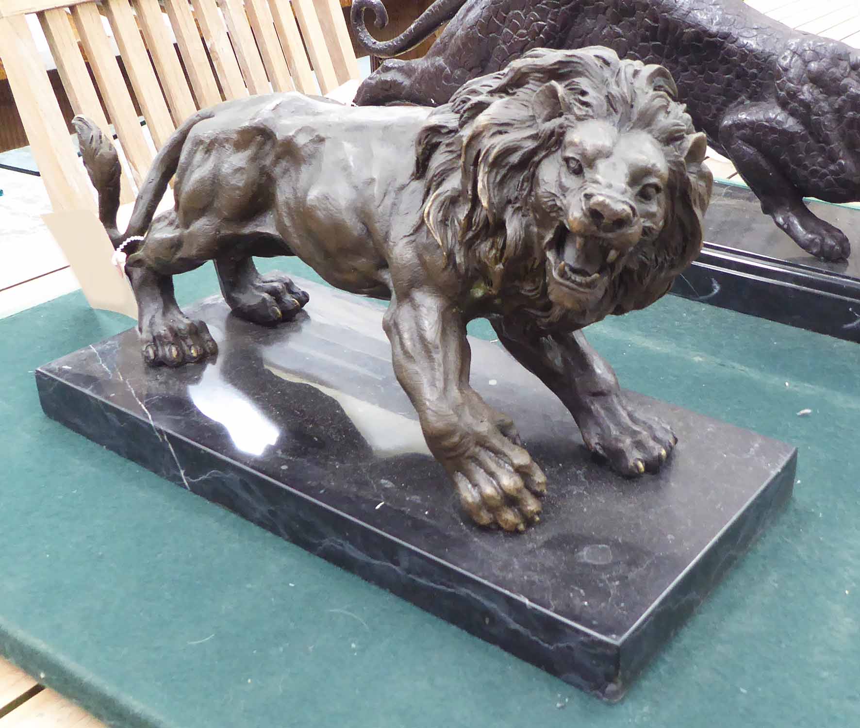 BRONZE LION, on marble base, 38cm L.