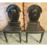 HALL CHAIRS, a pair, Victorian and later ebonised with arched backs.