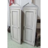 CONTINENTAL HANGING CORNER CUPBOARDS, a pair, grey painted with panelled doors,