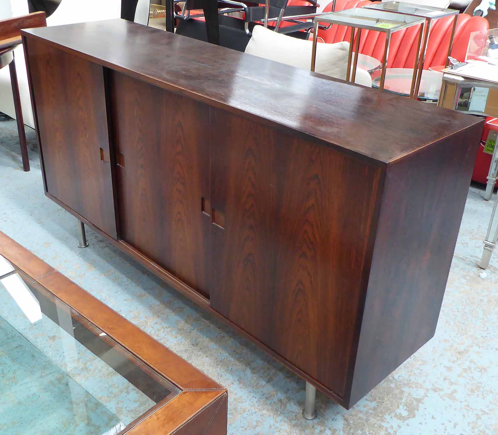 1960'S SIDEBOARD, with three sliding doors and fitted interior on metal tubular supports,