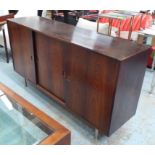 1960'S SIDEBOARD, with three sliding doors and fitted interior on metal tubular supports,