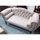SOFA, two seater, of small proportions, in neutral buttoned fabric on turned castor supports,