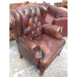 CLUB ARMCHAIR, in tanned leather button back with studded arms on rounded supports, 90cm W.