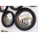 CONVEX WALL MIRRORS, a pair, Regency style, moulded black surround with gilt trim.