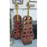 WINE RACKS, a pair, for ten bottles, in the form of an ornately painted guitar, 130cm H.