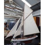 MODEL YACHT, in wood, on stand, 144cm L x 151cm H.